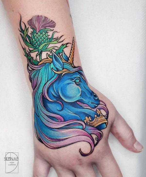Blue unicorn and thistle tattoo