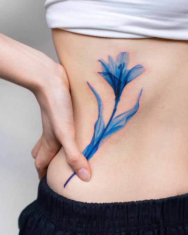 Blue watercolor lily side tattoo