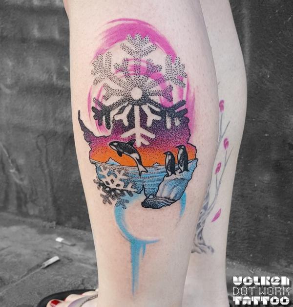 Colored snowflake and penguin dotwork tattoo