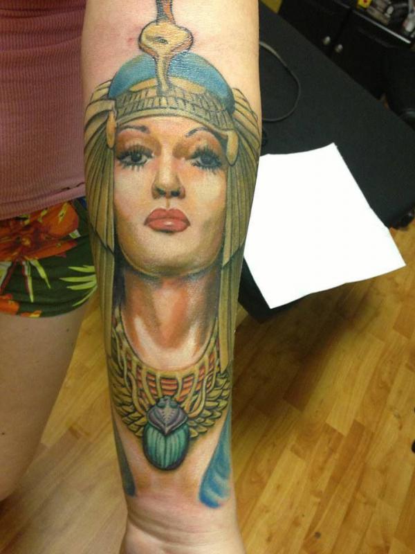 Colorful Cleopatra portrait and Scarab tattoo on forearm