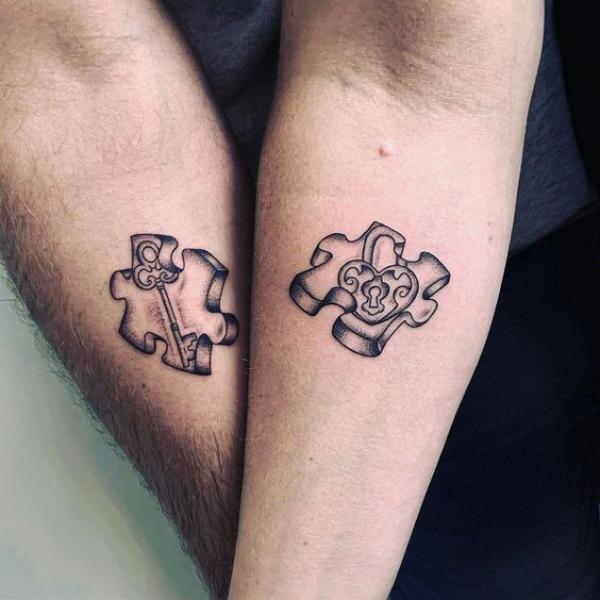 Couple puzzle tattoo with lock and key