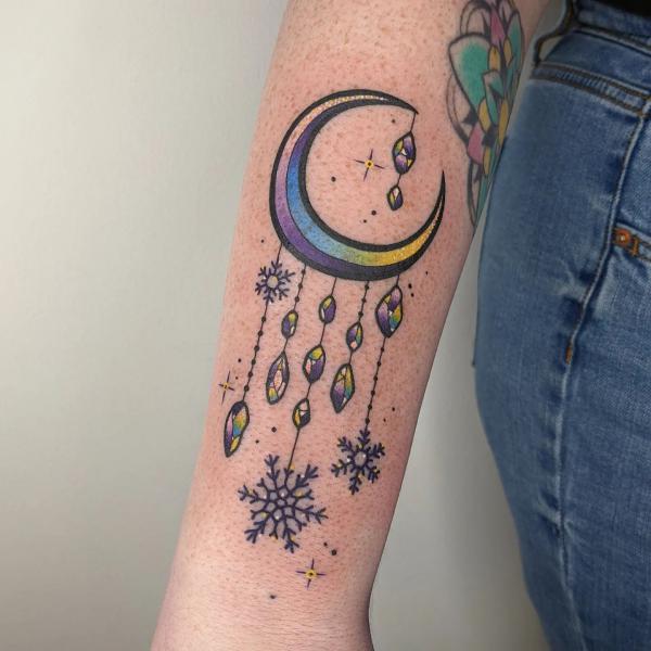 Crescent moon with snowflake pendant tattoo