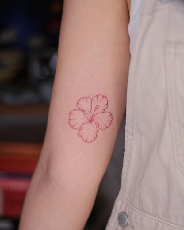Dainty hibiscus tattoo on bicep