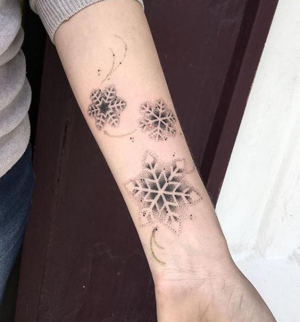 Dotwork snowflake inner forearm tattoo