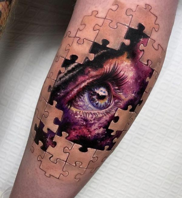 Eye in puzzle pieces tattoo