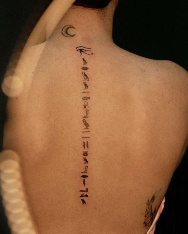 Eye of Horus and Hieroglyphics spine tattoo