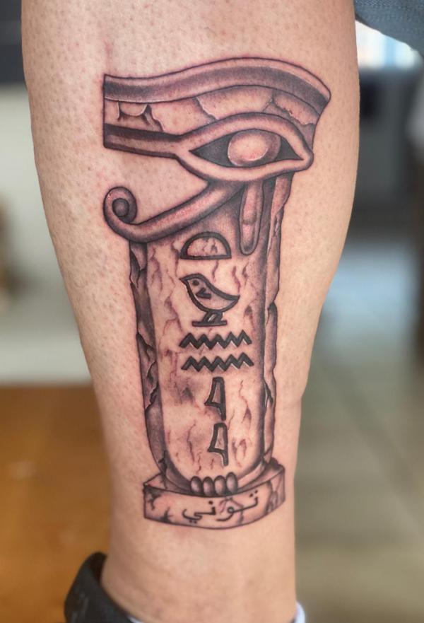 Eye of Ra and Cartouche Hieroglyphics carved tattoo