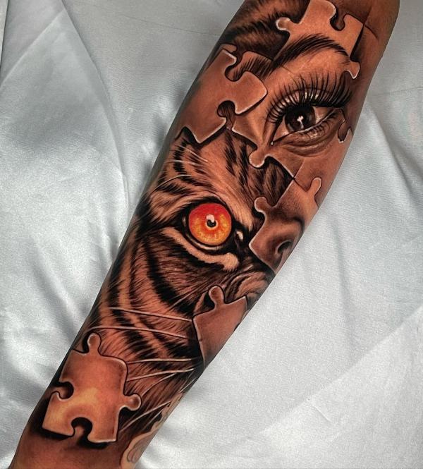 Eyes and puzzle forearm tattoo