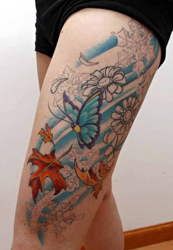 Fall leaf butterfly and snowflake thigh tattoo