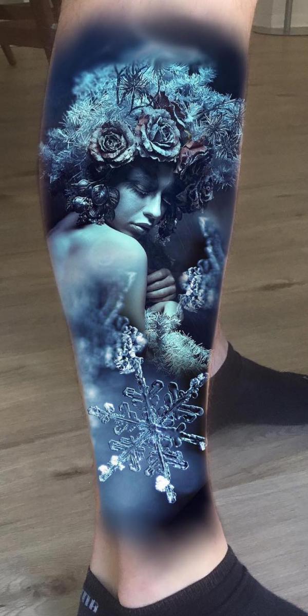 Female and snowflake lower leg tattoo