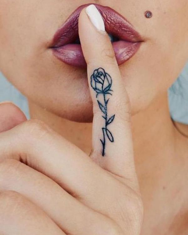 Fine line rose tattoo in index finger