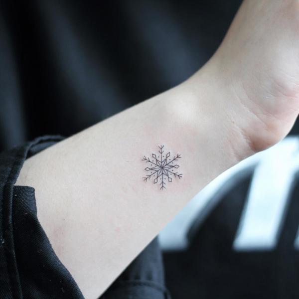 Fine line snowflake tattoo