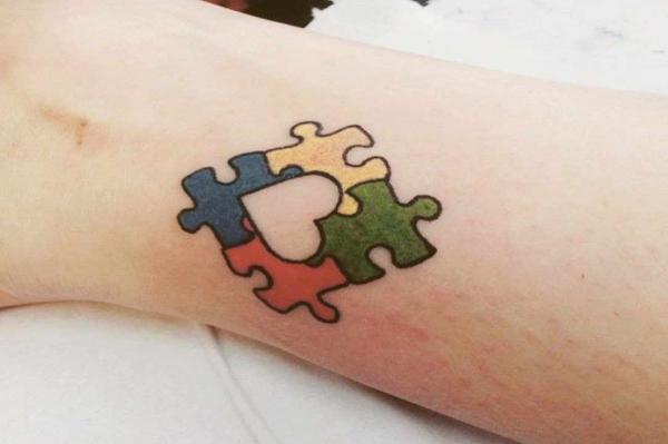 Four puzzle pieces autismo tattoo