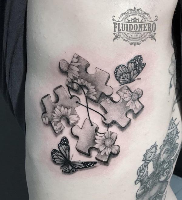 Four puzzle with butterfly and daisy tattoo