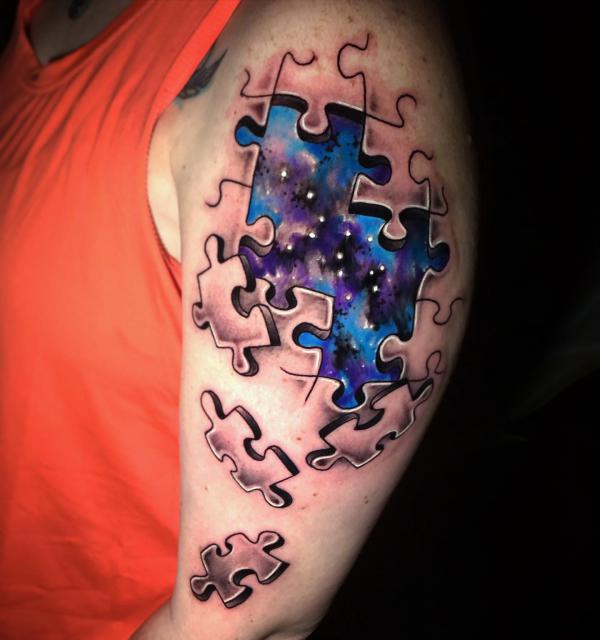 Galaxy within puzzle pieces tattoo
