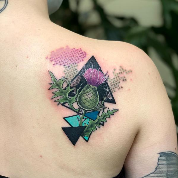 Geometric thistle shoulder blade tattoo