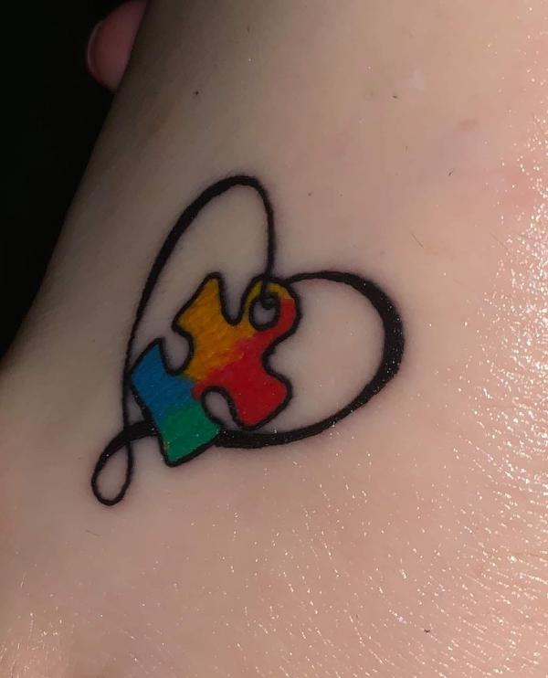 Heart outline with puzzle piece tattoo