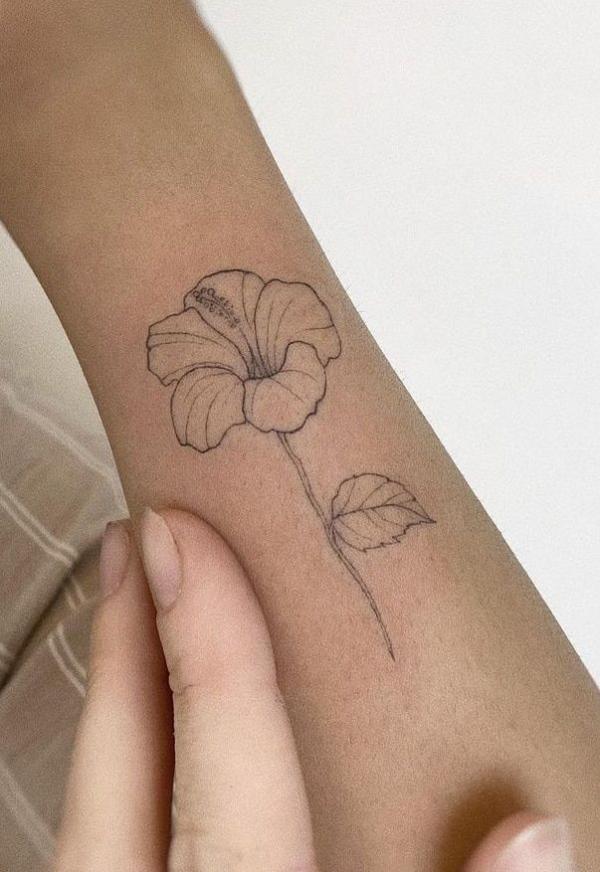 Hibiscus outline tattoo on forearm
