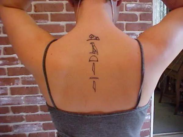 Hieroglyphs spine tattoo