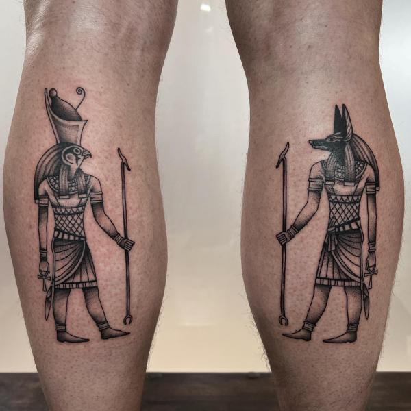 Horus and Anubis tattoo on calfs