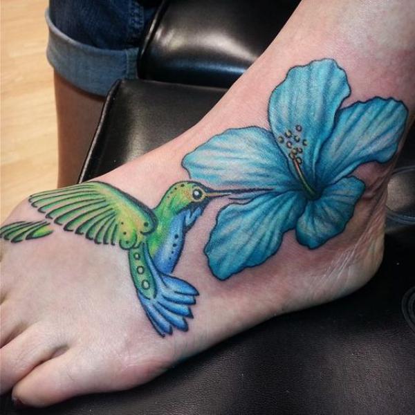 Hummingbird and blue hibiscus foot tattoo