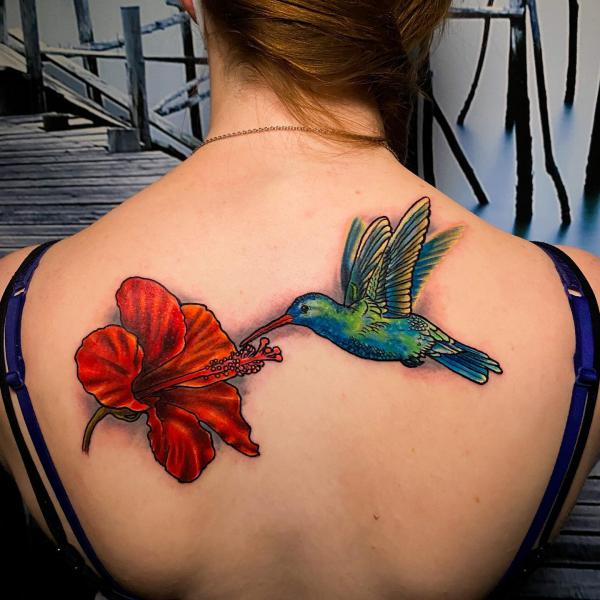 Hummingbird and hibiscus back tattoo