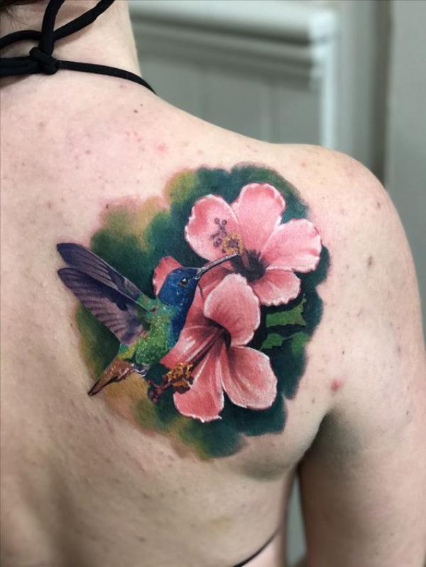 Hummingbird and hibiscus shoulder blade tattoo