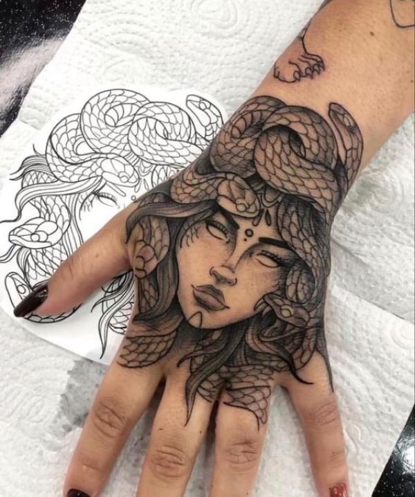 Medusa encircled with snakes hand tattoo