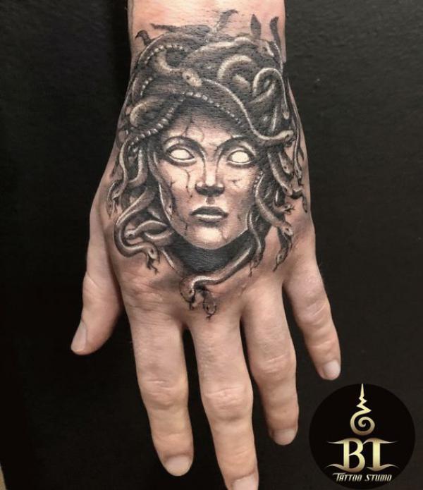 Medusa face hand tattoo black and grey