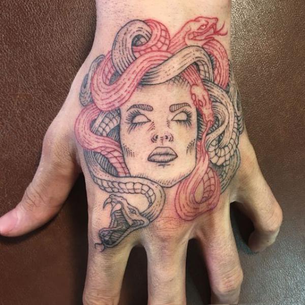 Medusa with red and grey snakes hand tattoo