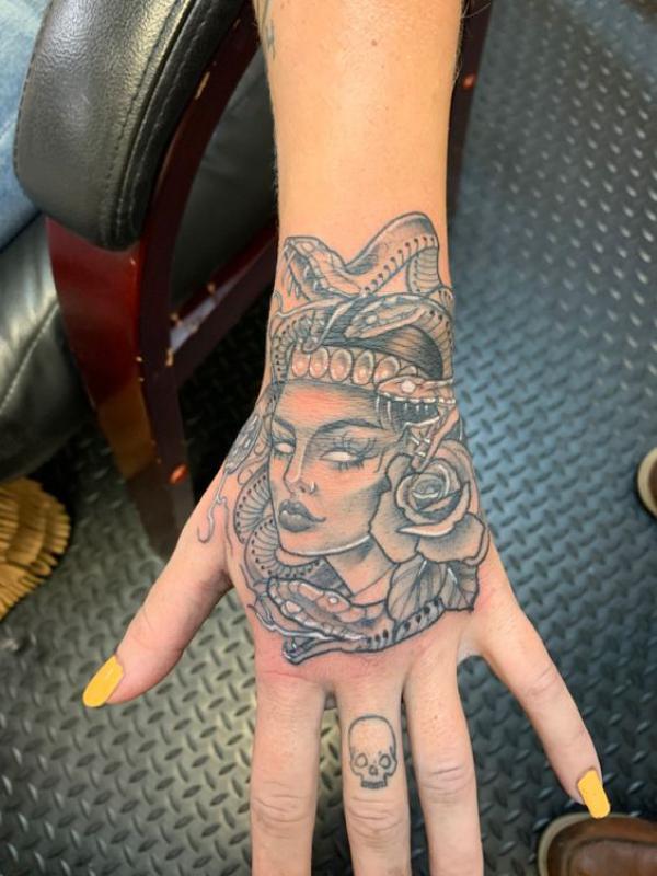 Medusa with snake and rose hand tattoo black and grey