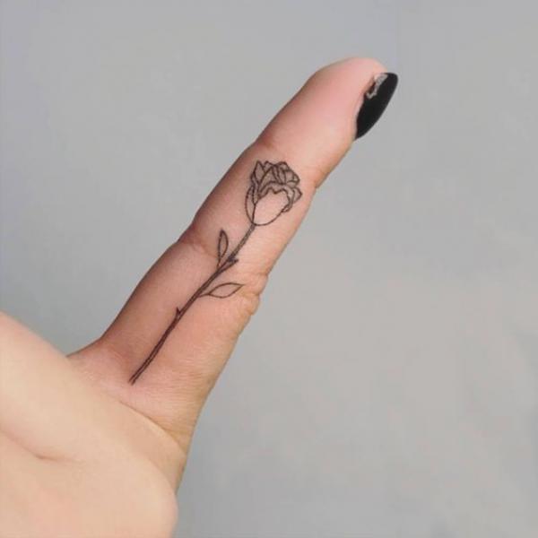 Minimalist rose finger tattoo