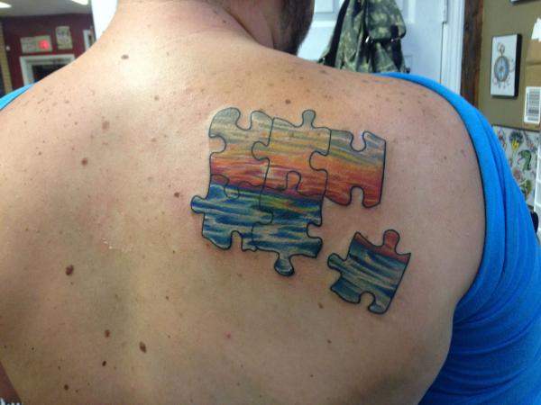 Ocean water and sunshine puzzles shoulder blade tattoo