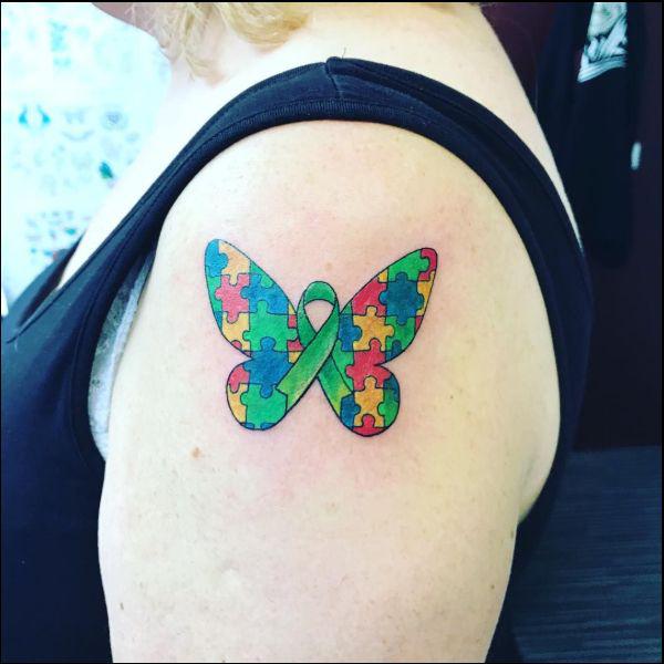 Puzzle butterfly with ribbon tattoo