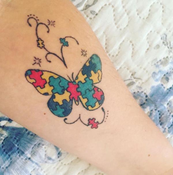 Puzzle butterfly with swirls tattoo