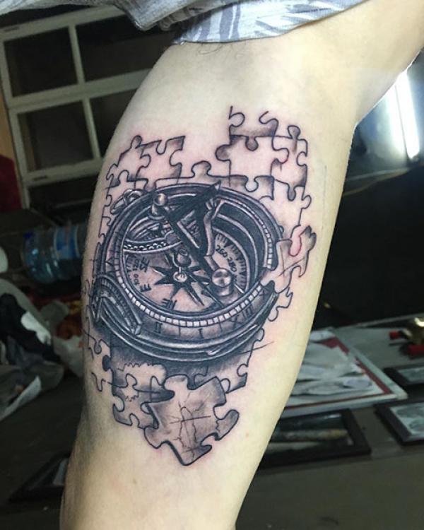 Puzzle compass tattoo on lower leg