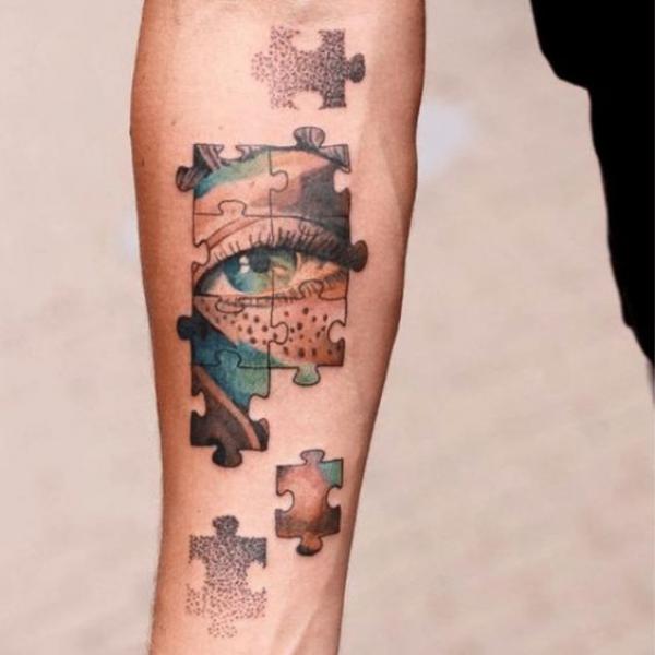 Puzzle eye forearm tattoo