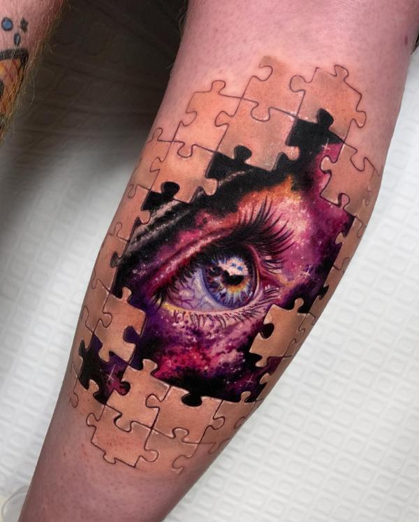 Puzzle eye tattoo on forearm