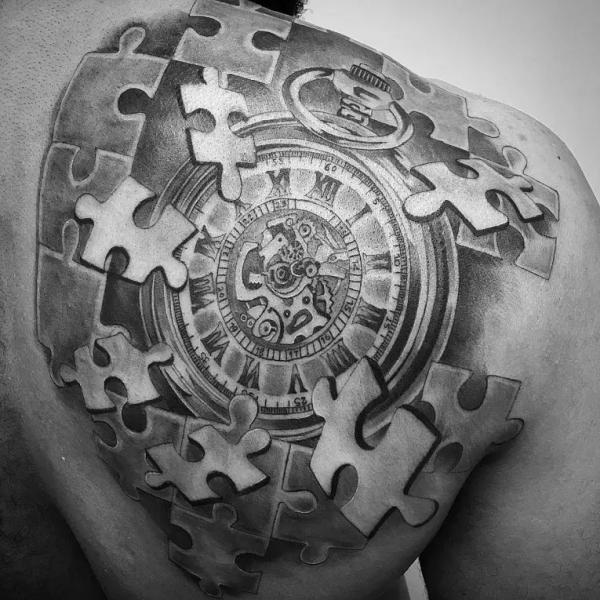 Puzzle pieces over pocket watch tattoo