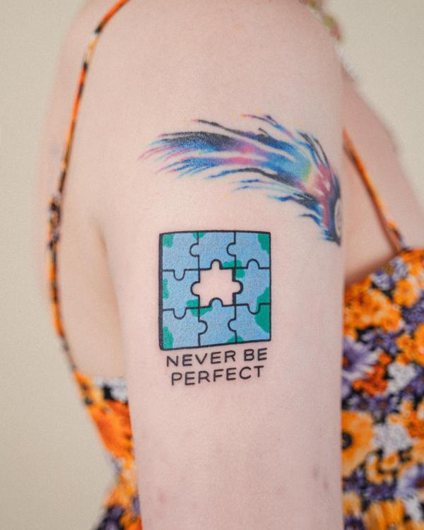 Puzzle tattoo with words Never Be Perfect