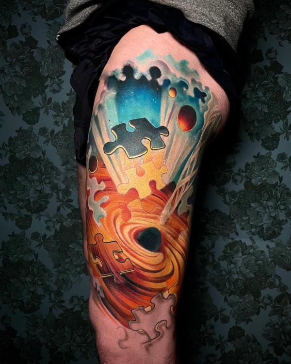 Puzzle with swirl half sleeve tattoo