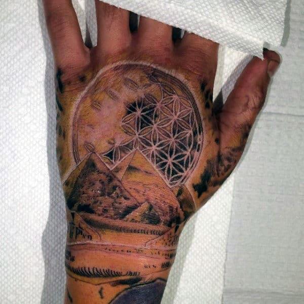 Pyramid and flower of life tattoo on hand