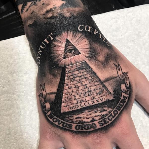 Pyramid with all seeing eye and words Novus Ordo SecloRuM tattoo