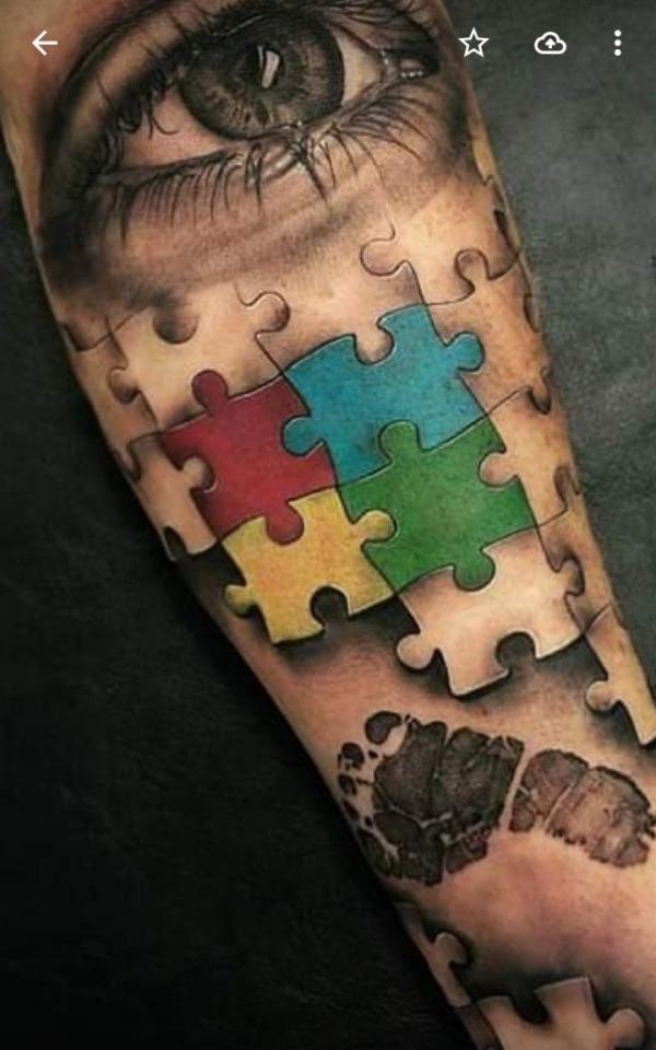 Realistic eye and puzzles with foot print tattoo