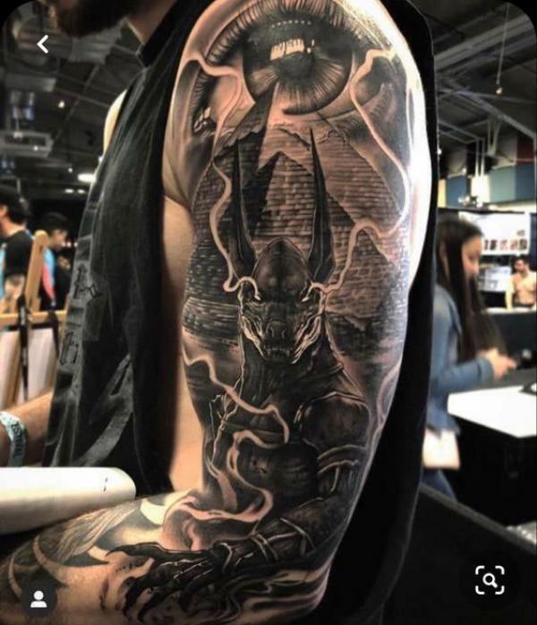 Realistic eye with Pyramid and Anubis tattoo sleeve