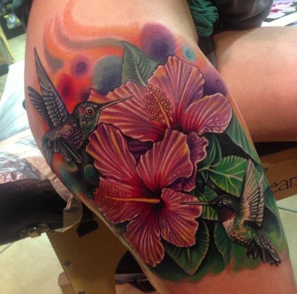Realistic hummingbird and hibiscus tattoo on thigh