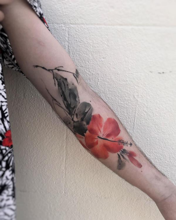 Red and black ink watercolor hibiscus sleeve tattoo