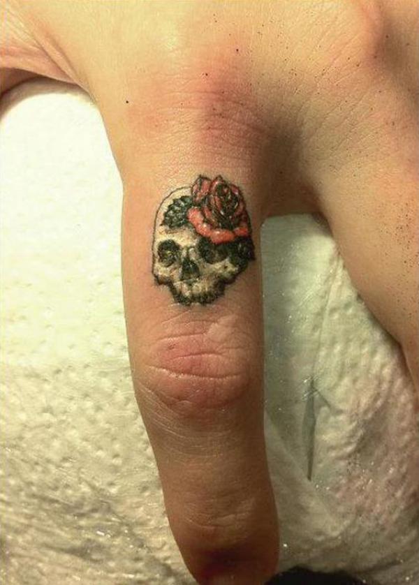Rose and skull finger tattoo