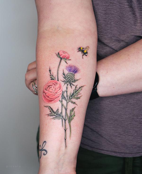 Rose thistle and bee forearm tattoo