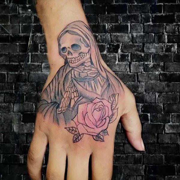 Santa Muerte and rose hand tattoo